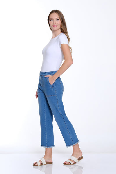 Woman wearing a white t-shirt and blue jeans on a white background