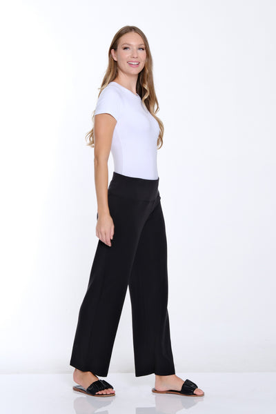 Woman wearing a white t-shirt and black pants on a white background
