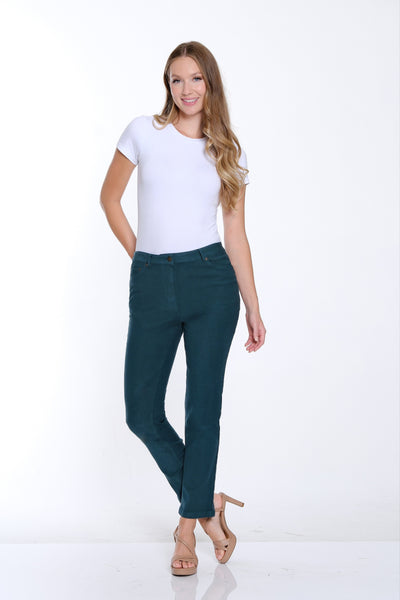 Woman wearing a white t-shirt and teal pants on a white background