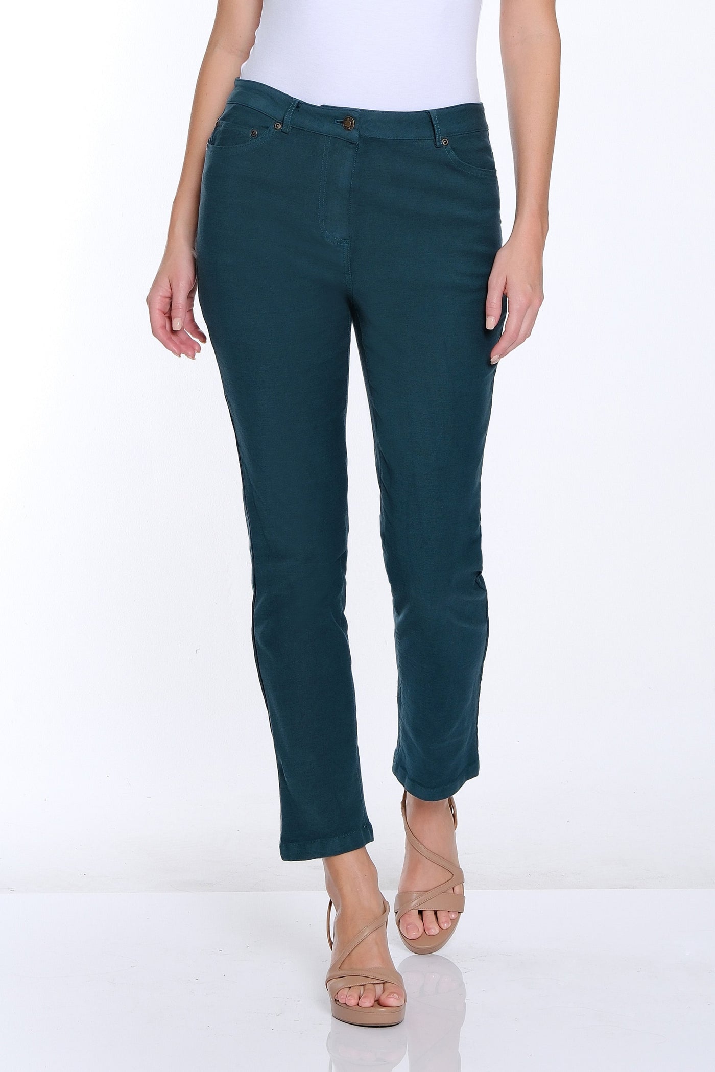 Woman wearing a white t-shirt and teal pants on a white background
