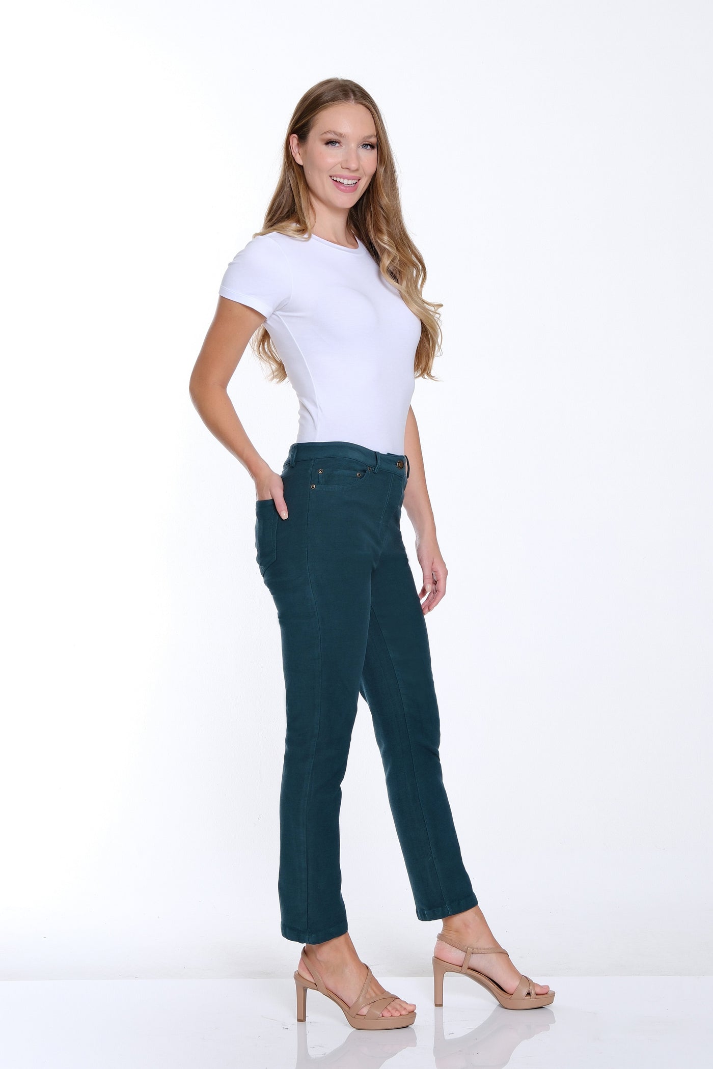 Woman wearing a white t-shirt and dark green pants on a white background