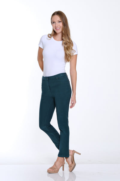 Woman wearing a white t-shirt and teal pants on a white background