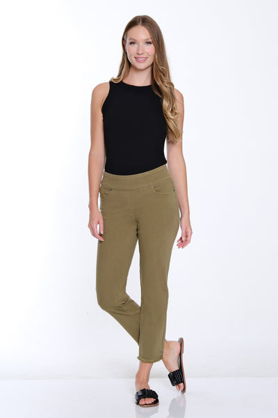 Woman wearing a black top and green pants on a white background