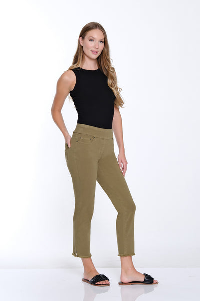 Woman wearing a black sleeveless top and green pants on a white background