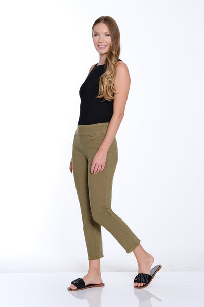 Woman wearing a black top and green pants on a white background