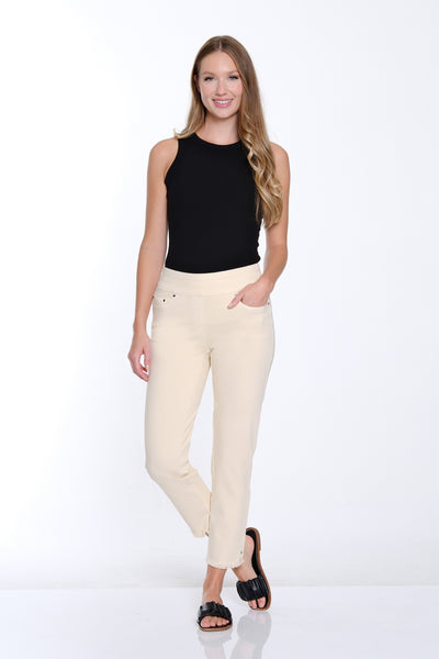 Woman wearing a black top and white pants on a white background