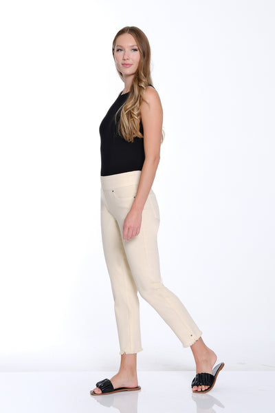 Woman wearing a black top and white pants on a white background