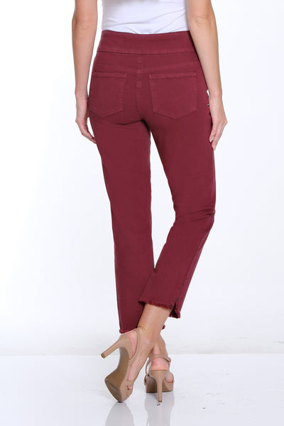 Woman wearing maroon pants and a white top on a white background