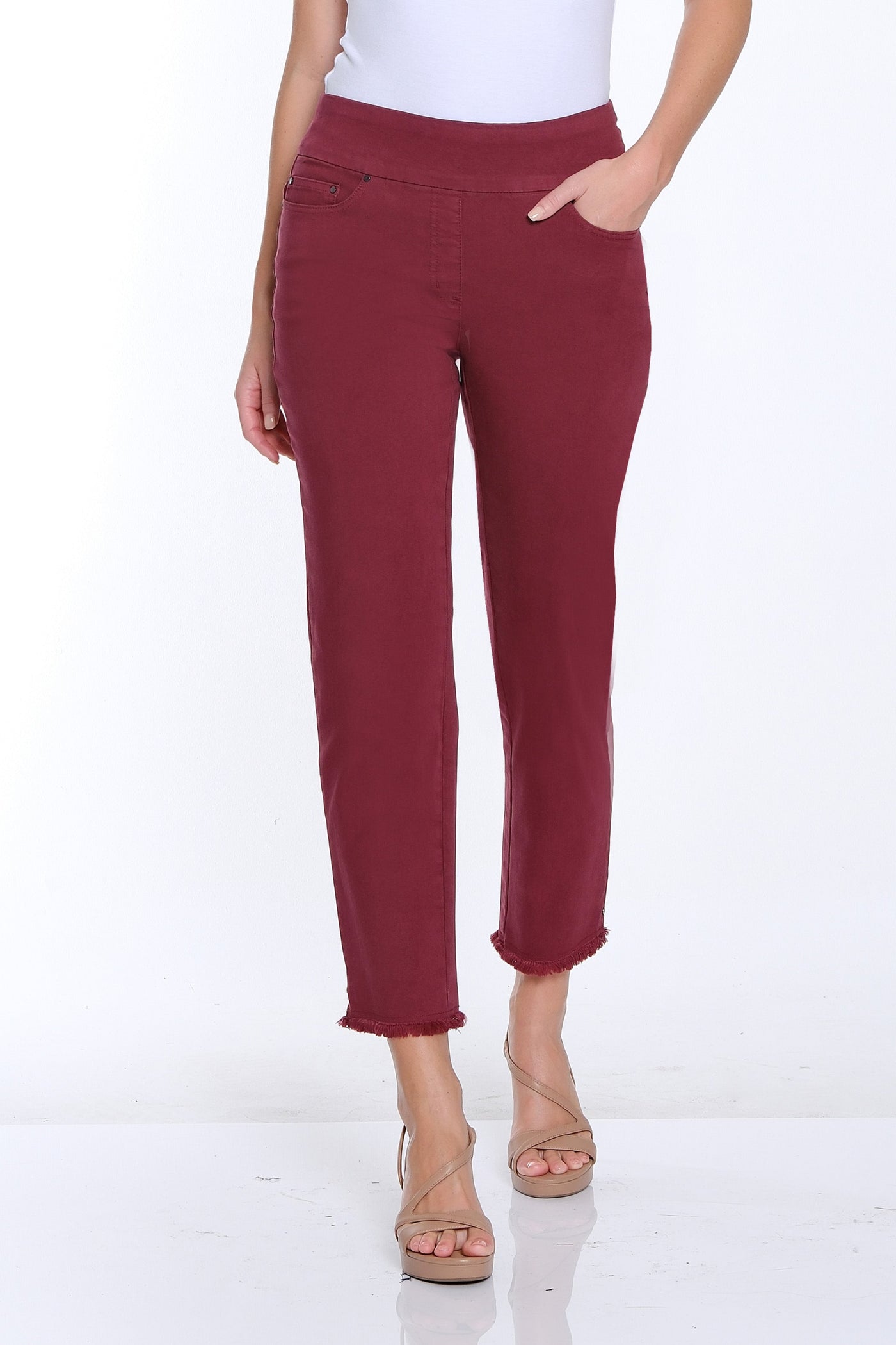 Woman wearing a white t-shirt and red pants on a white background