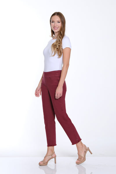 Woman wearing a white top and burgundy pants on a white background