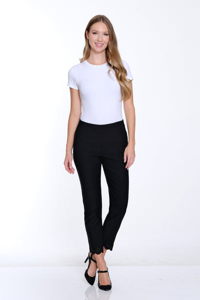 Woman wearing a white t-shirt and black pants on a white background