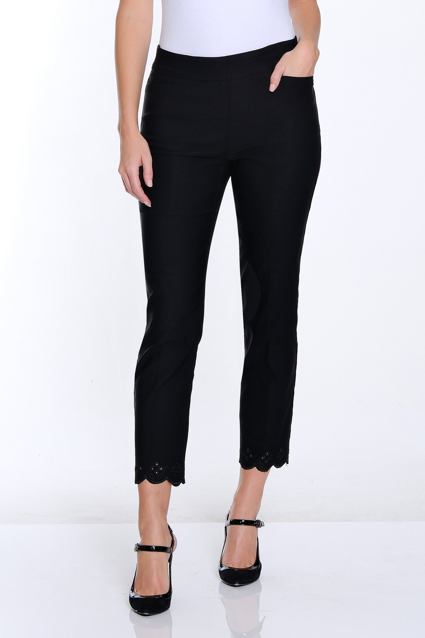 Woman wearing a white t-shirt and black pants on a white background