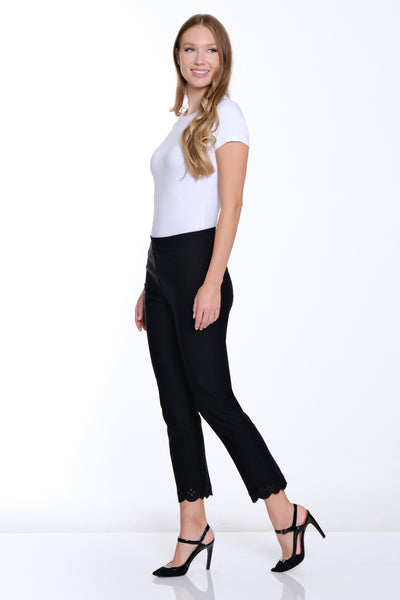 Woman wearing a white top and black pants on a white background