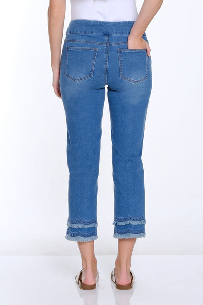 Woman wearing blue jeans and a white top on a white background