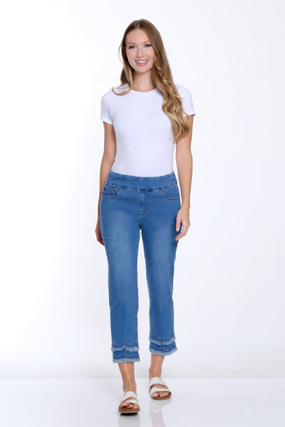 Woman wearing a white t-shirt and blue jeans on a white background
