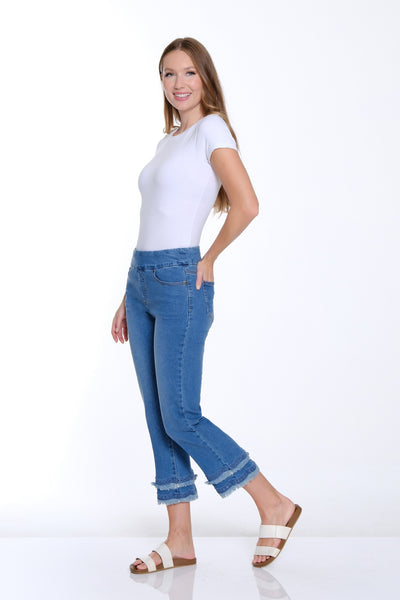 Woman wearing a white t-shirt and blue jeans on a white background