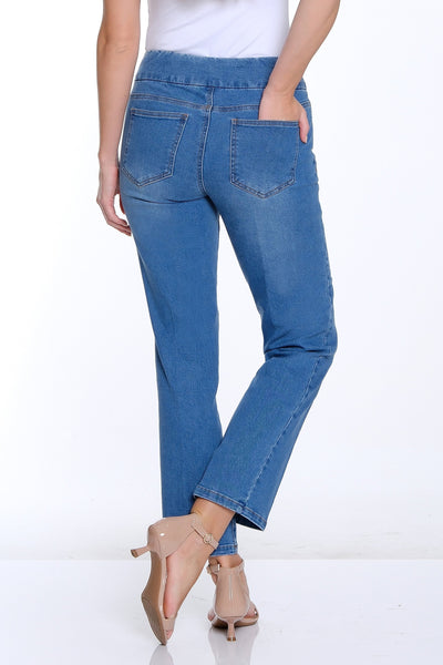Woman wearing blue jeans and a white top on a white background