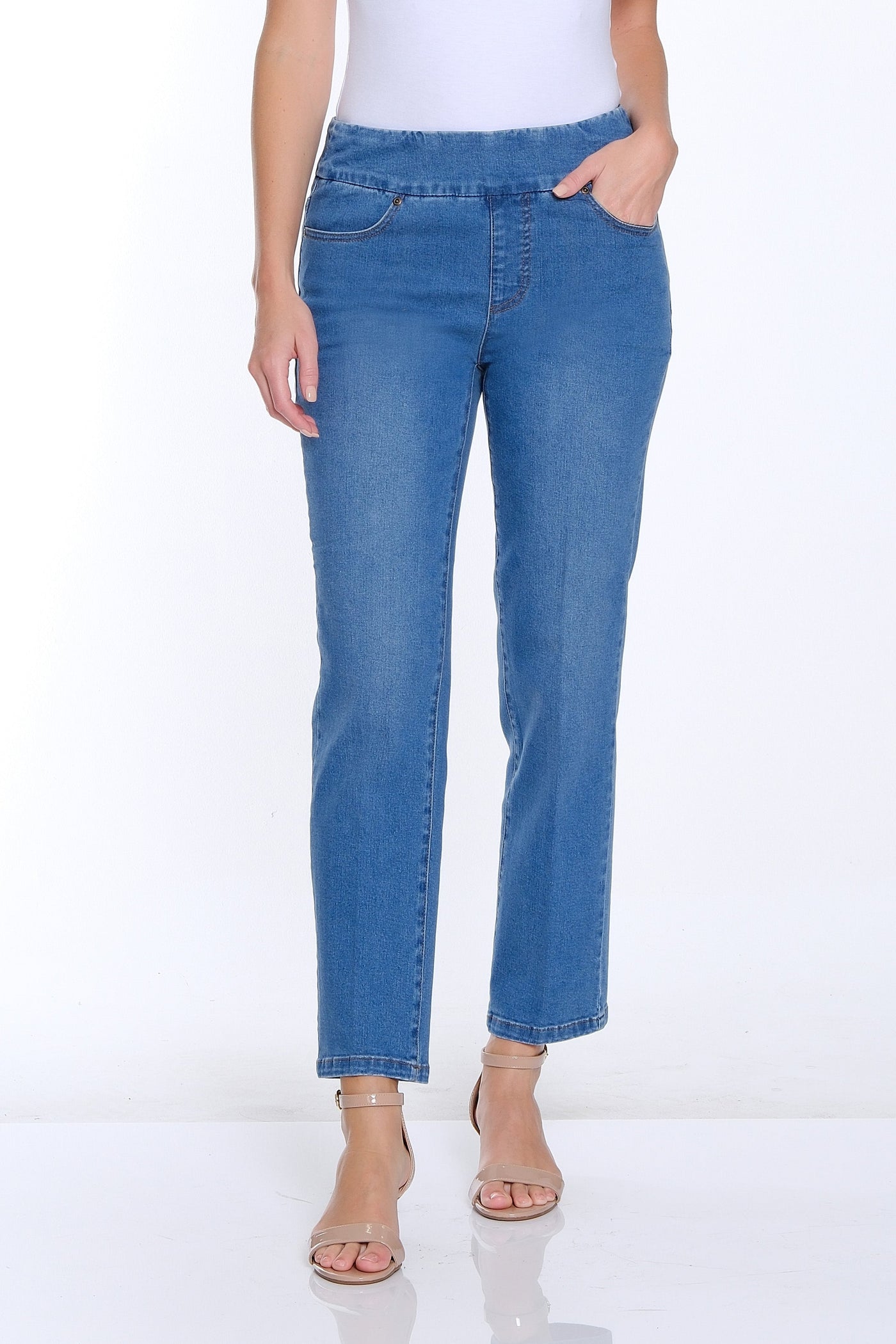 Woman wearing a white t-shirt and blue jeans on a white background