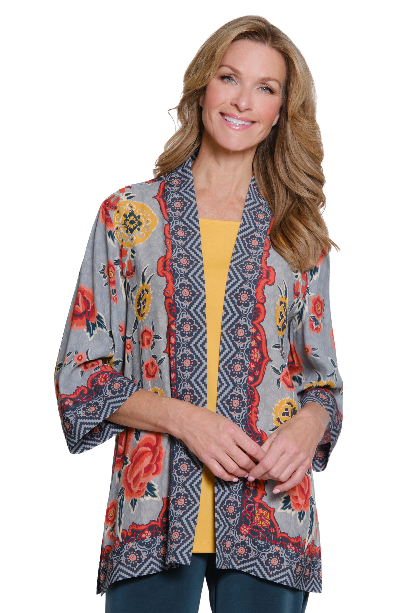 Woman wearing a patterned kimono-style jacket on a white background