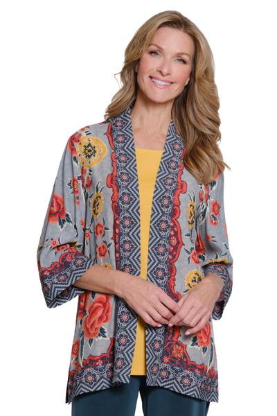 Woman wearing a patterned kimono-style jacket on a white background