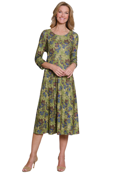 Woman wearing a green floral dress on a white background